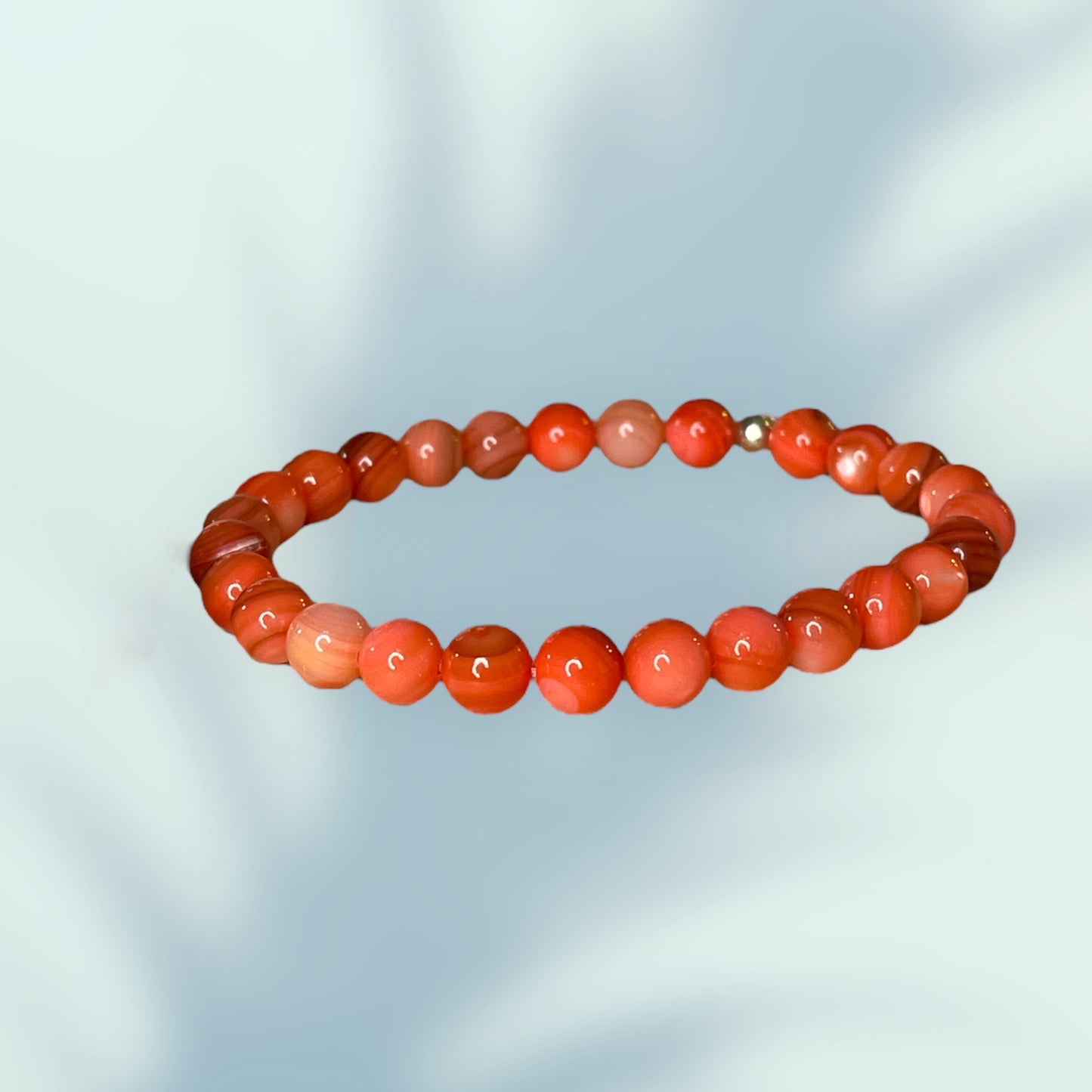 Orange/peach calcite bead bracelet with multiple shades of color