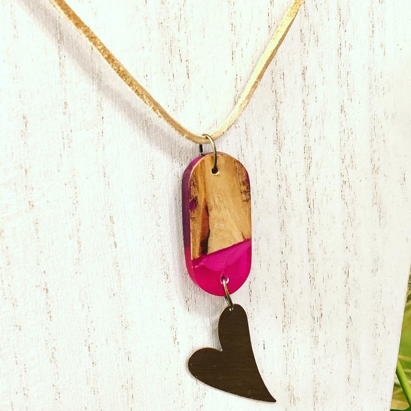 Red resin and wood pendant with copper heart charm attached, suspended on Beige leather/suede necklace.